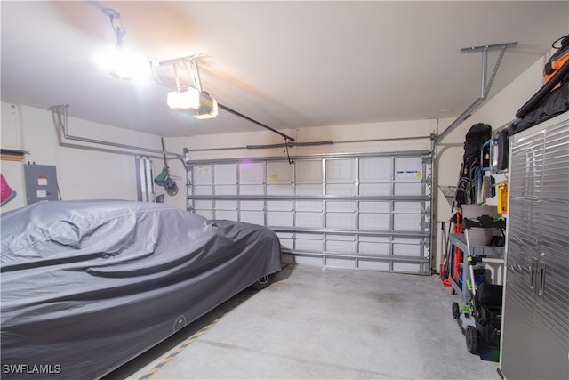 garage with electric panel and a garage door opener