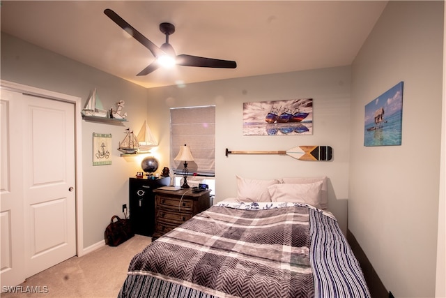 carpeted bedroom featuring ceiling fan and a closet