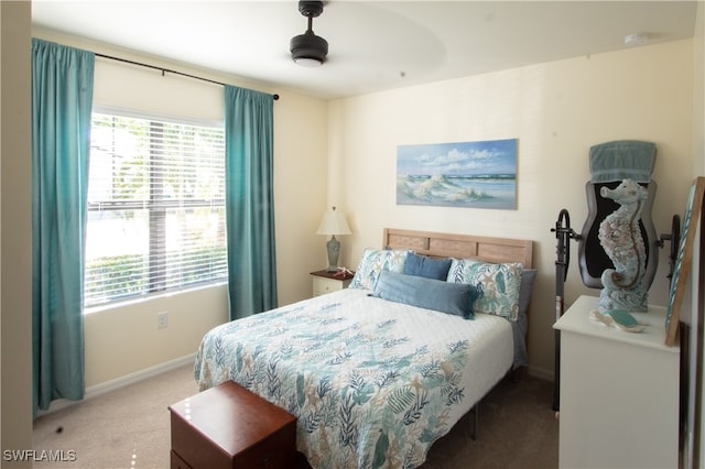 bedroom featuring carpet flooring, multiple windows, and ceiling fan