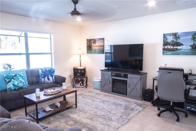 living room featuring tile patterned flooring and ceiling fan