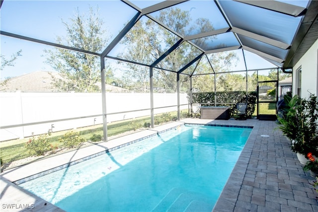 view of pool with glass enclosure