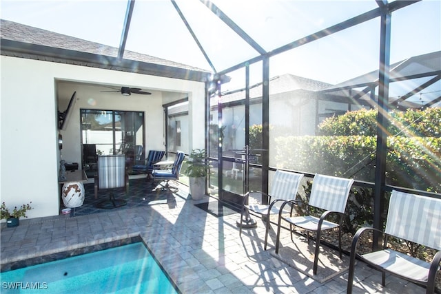 view of pool with a lanai, ceiling fan, and a patio area