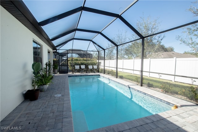 view of pool featuring a patio and a lanai