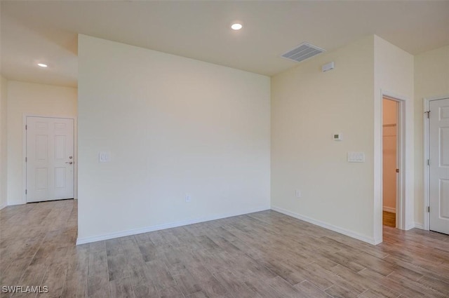 spare room with light hardwood / wood-style floors