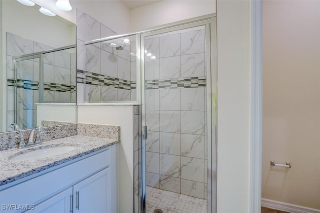 bathroom with vanity and a shower with shower door