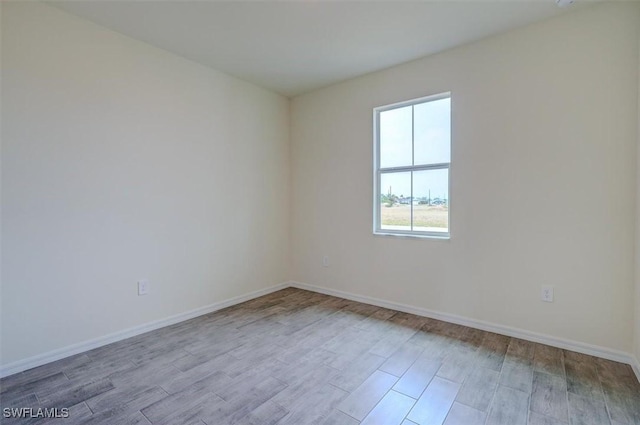 spare room with light hardwood / wood-style flooring