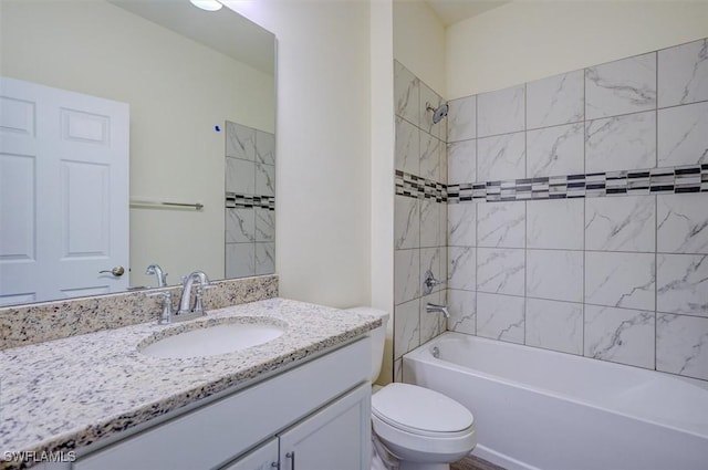 full bathroom with vanity, toilet, and tiled shower / bath