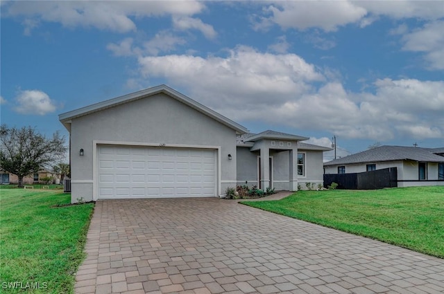 single story home featuring a garage, central air condition unit, and a front yard