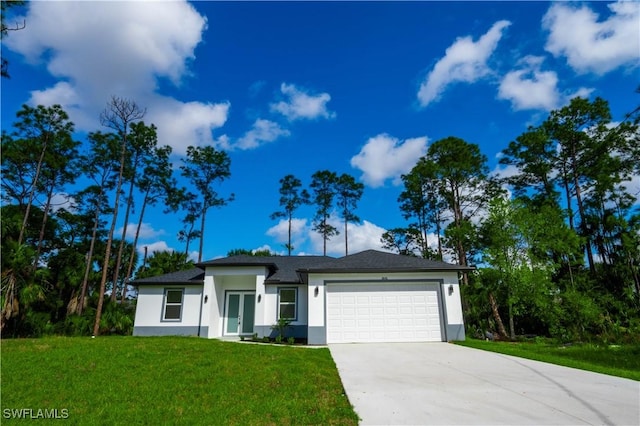 view of front of home featuring a front yard and a garage