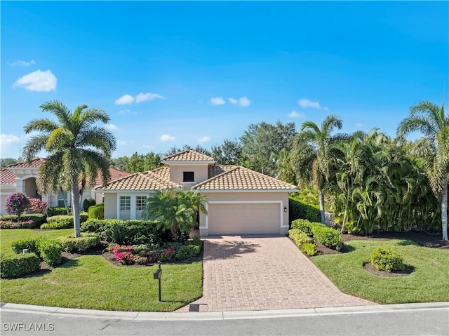 19550 Casa Bendita Ct, Estero, FL 33967 - mediterranean / spanish-style house featuring an attached garage, stucco siding, a front yard, a tile roof, and driveway