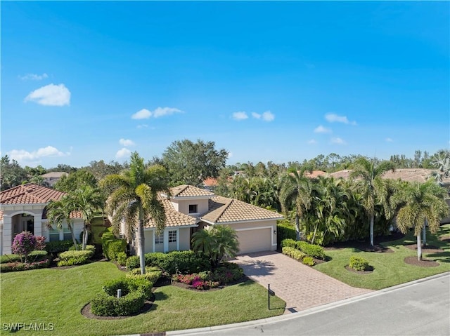 19550 Casa Bendita Ct, Estero, FL 33967 - mediterranean / spanish house with a garage, a tile roof, driveway, and a front lawn