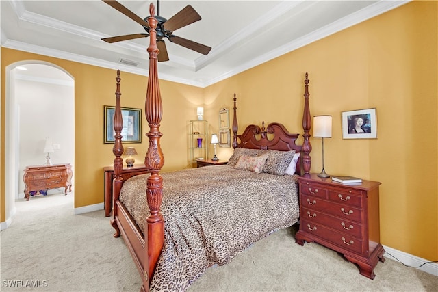 bedroom featuring crown molding, ceiling fan, a raised ceiling, and light colored carpet