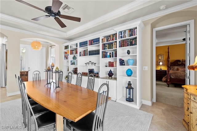 19550 Casa Bendita Ct, Estero, FL 33967 - dining room featuring ceiling fan, arched walkways, ornamental molding, light tile patterned flooring, and light carpet