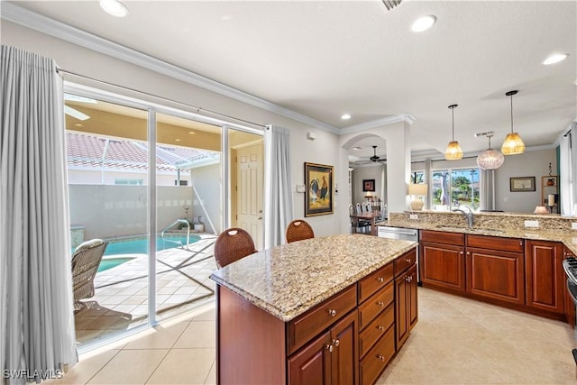 19550 Casa Bendita Ct, Estero, FL 33967 - kitchen featuring ceiling fan, light stone countertops, crown molding, hanging light fixtures, and light tile patterned flooring