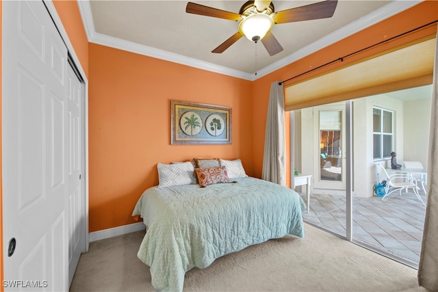 bedroom featuring crown molding, ceiling fan, a closet, and light carpet