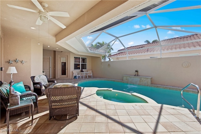 view of swimming pool featuring an in ground hot tub, ceiling fan, a lanai, and a patio area