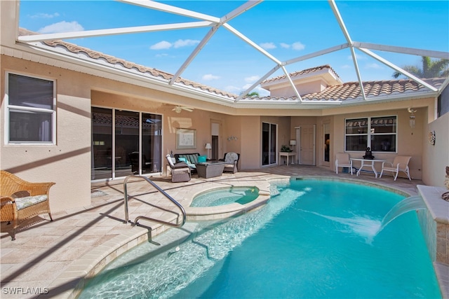 view of pool featuring an in ground hot tub, ceiling fan, a lanai, and a patio area