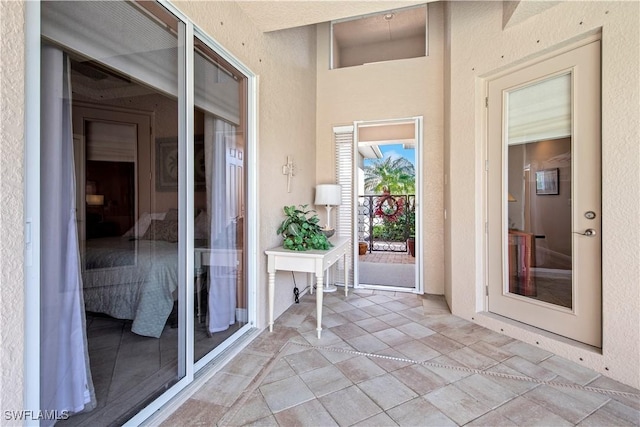 19550 Casa Bendita Ct, Estero, FL 33967 - view of exterior entry with stucco siding and a balcony