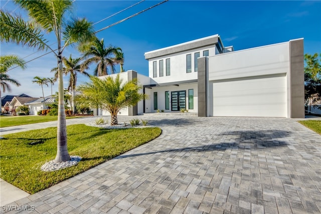 modern home with a garage and a front lawn