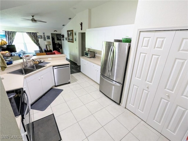 kitchen featuring ceiling fan, sink, white cabinets, and stainless steel appliances