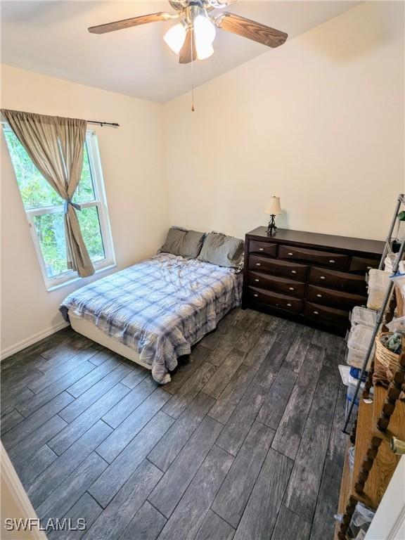 bedroom featuring ceiling fan and dark wood-type flooring