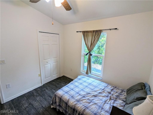 bedroom featuring ceiling fan, a closet, dark hardwood / wood-style floors, and vaulted ceiling