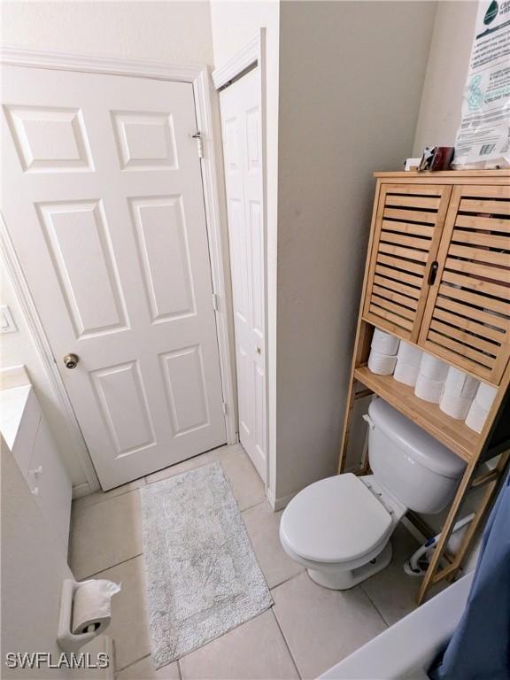 bathroom with toilet and tile patterned floors