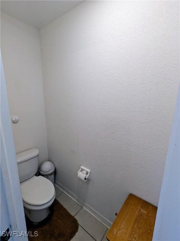 bathroom featuring tile patterned flooring and toilet