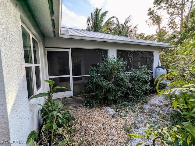 view of side of property featuring a sunroom