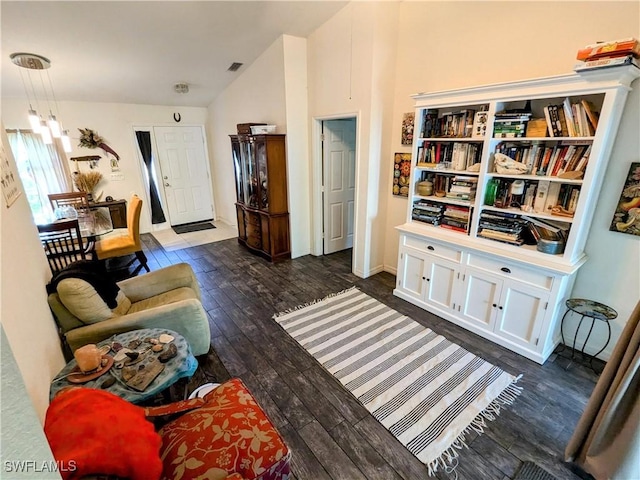 living area with vaulted ceiling and dark wood-type flooring