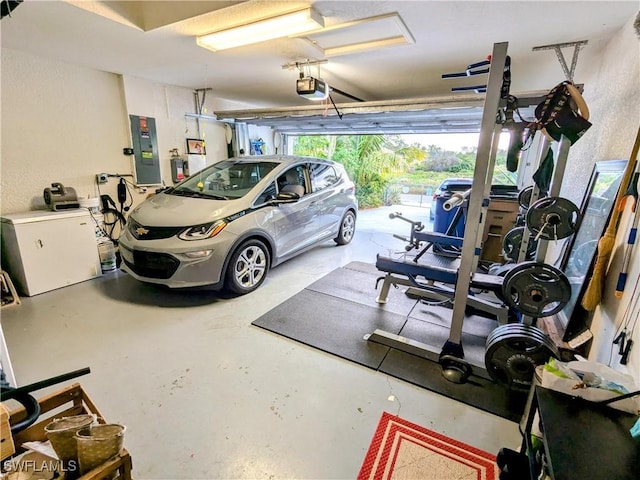 garage featuring electric panel, a garage door opener, and washer / clothes dryer