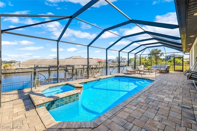 view of swimming pool with a lanai, a boat dock, a patio area, an in ground hot tub, and a water view