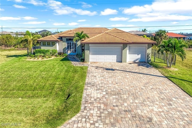 ranch-style home featuring a garage and a front lawn