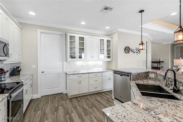 kitchen with white cabinetry, sink, pendant lighting, and appliances with stainless steel finishes