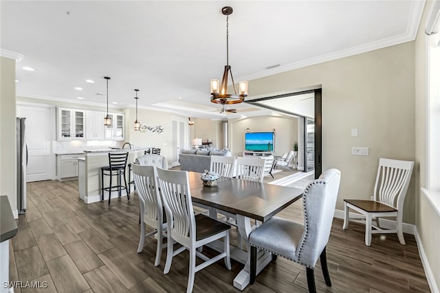 dining space with a chandelier, dark hardwood / wood-style flooring, and crown molding