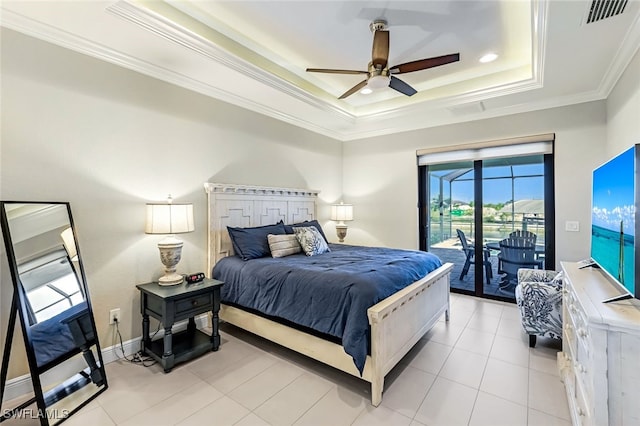 bedroom featuring ceiling fan, access to exterior, ornamental molding, light tile patterned floors, and a tray ceiling