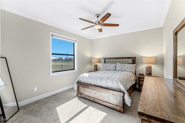 bedroom featuring ceiling fan, crown molding, and light carpet