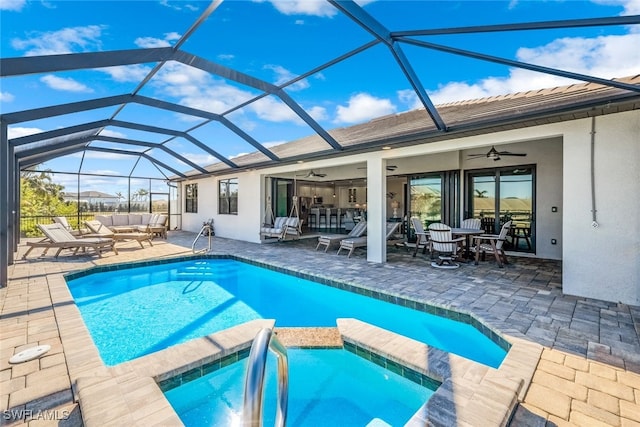 view of pool with ceiling fan, a lanai, an outdoor living space, and a patio