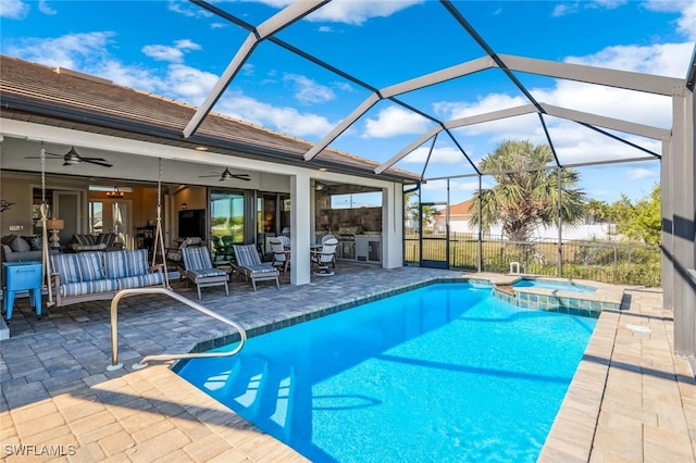 view of swimming pool with an outdoor living space, glass enclosure, ceiling fan, an in ground hot tub, and a patio