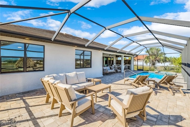 view of patio / terrace featuring outdoor lounge area, glass enclosure, and ceiling fan