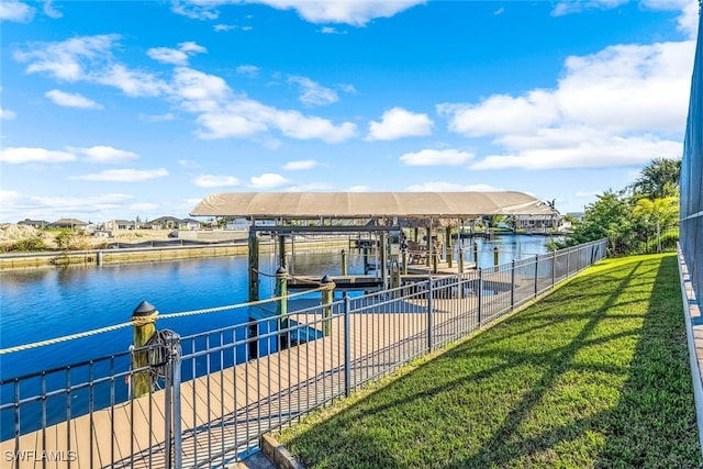 dock area featuring a lawn and a water view