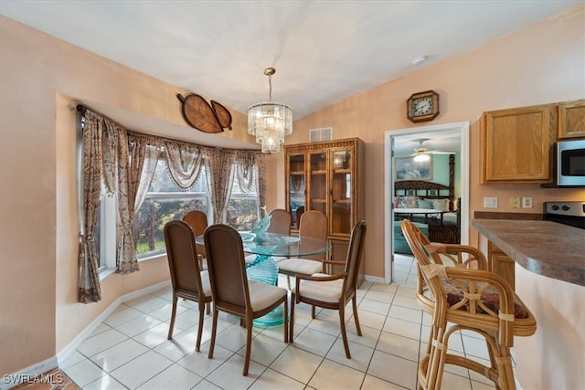 dining space featuring light tile patterned floors and ceiling fan with notable chandelier