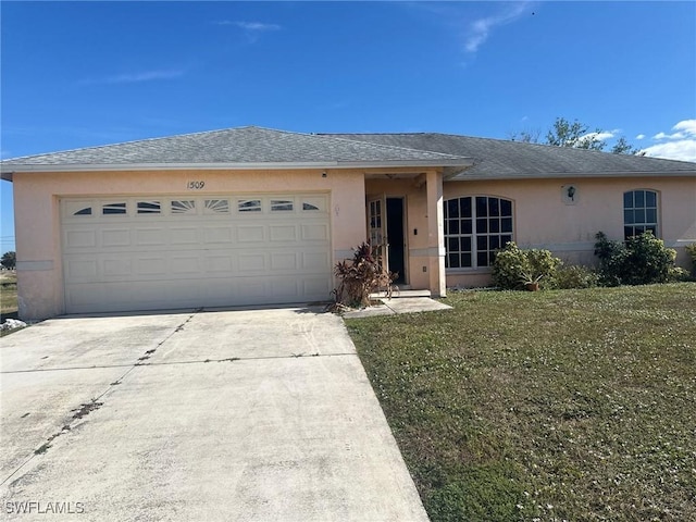 single story home featuring a garage and a front lawn