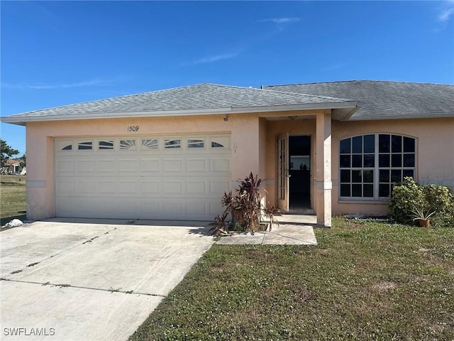 single story home with a garage and a front lawn