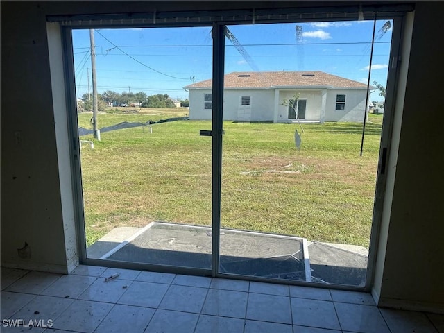 doorway to outside with light tile patterned floors