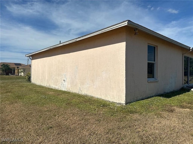 view of property exterior with a lawn