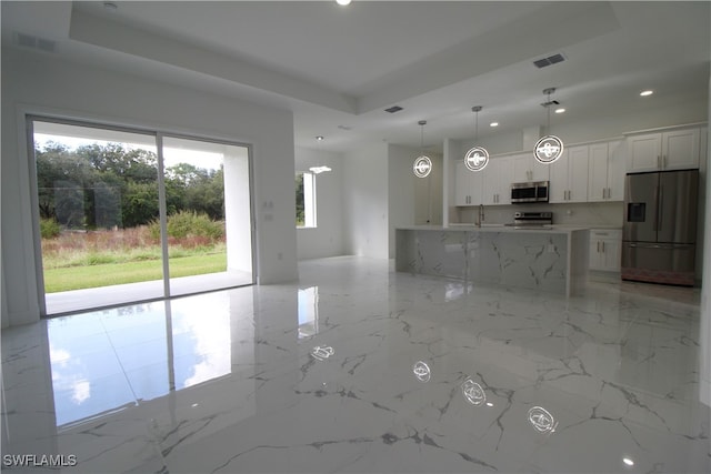 interior space with sink and a tray ceiling