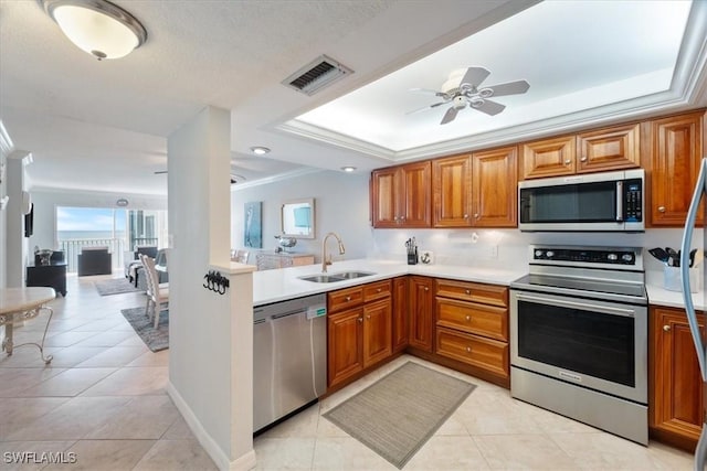 kitchen featuring crown molding, sink, light tile patterned floors, and stainless steel appliances