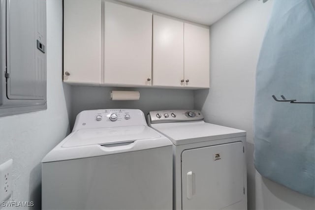 laundry area featuring electric panel, cabinets, and independent washer and dryer