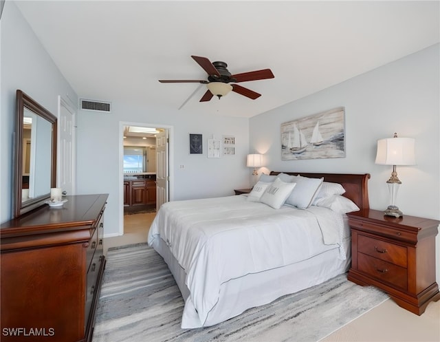 bedroom featuring ceiling fan and connected bathroom